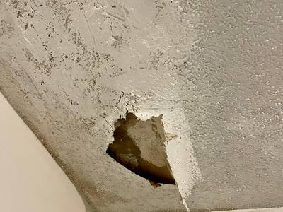 Severe ceiling damage and hole from roof leak — Broward County FL