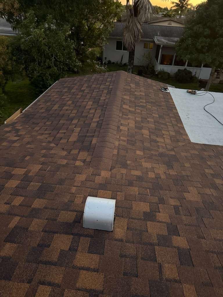 Dark brown asphalt shingle roof installation at sunset in Dania Beach, FL — Broward Roofing Pros