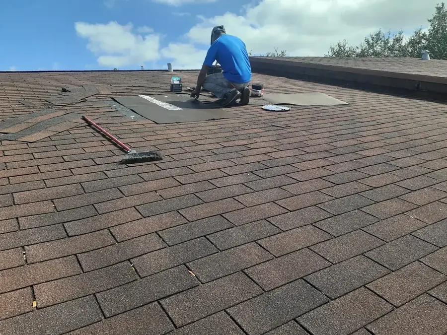 Professional roofer repairing asphalt shingle roof in Hollywood, FL — Broward Roofing Pros