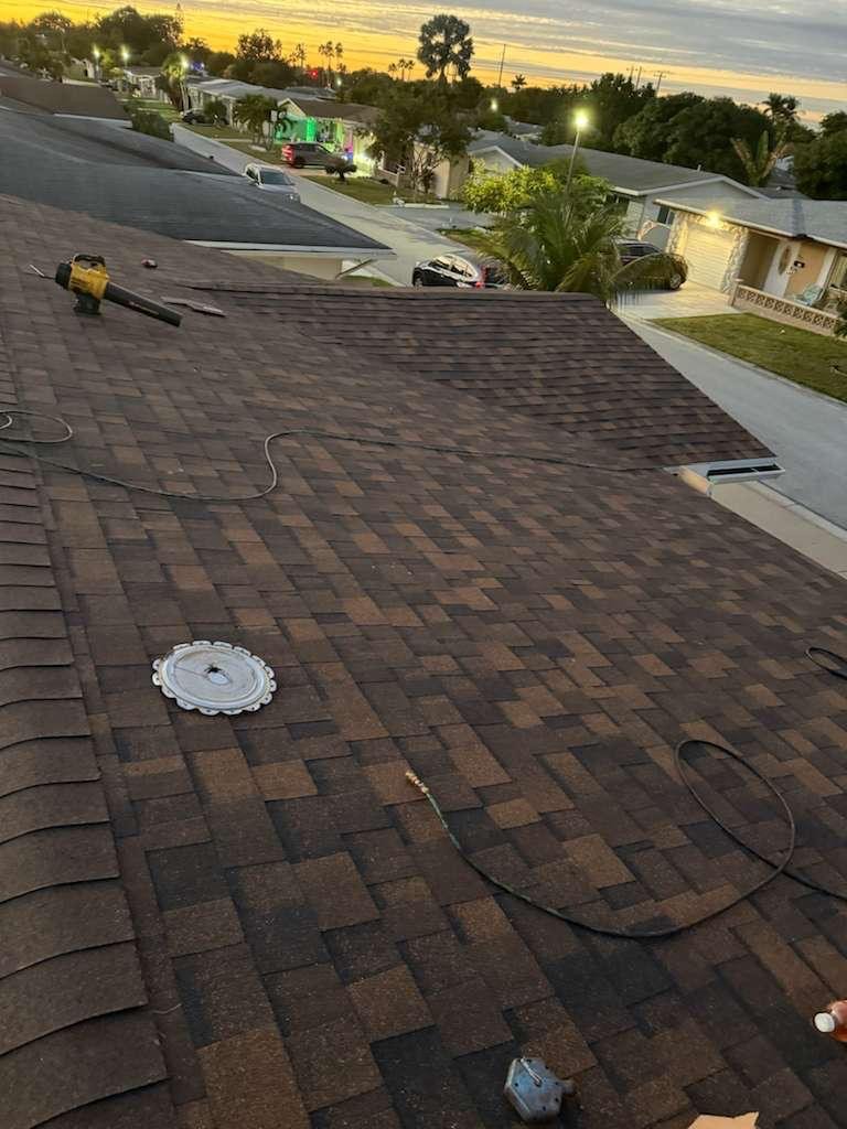 Asphalt shingle roof replacement in progress at sunset in Margate, FL — Broward Roofing Pros