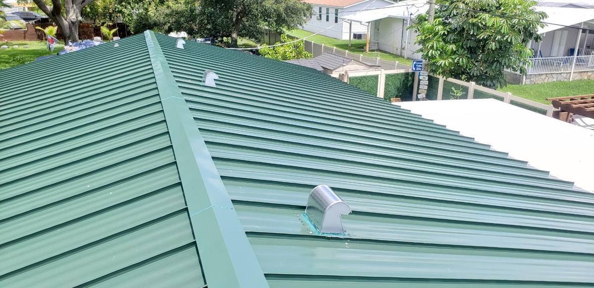 Green standing seam metal roof installation in Oakland Park, FL — Broward Roofing Pros