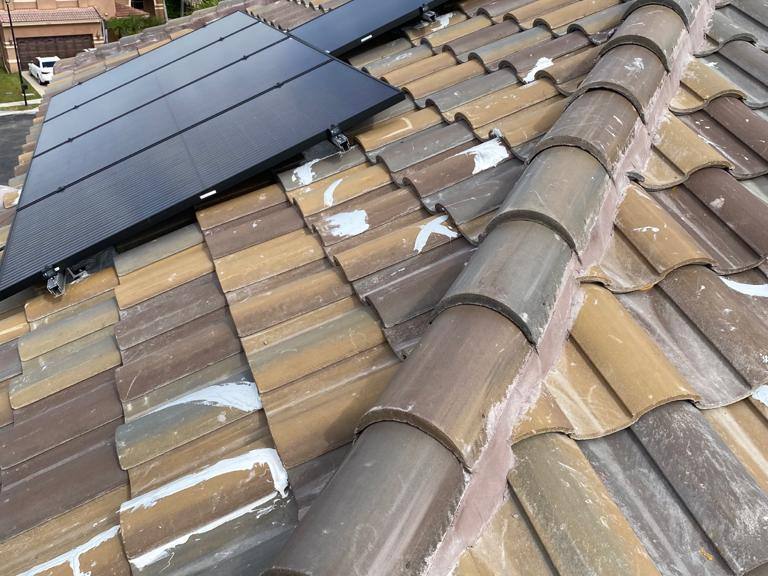 Tile roof with solar panel installation in Plantation, FL — Broward Roofing Pros
